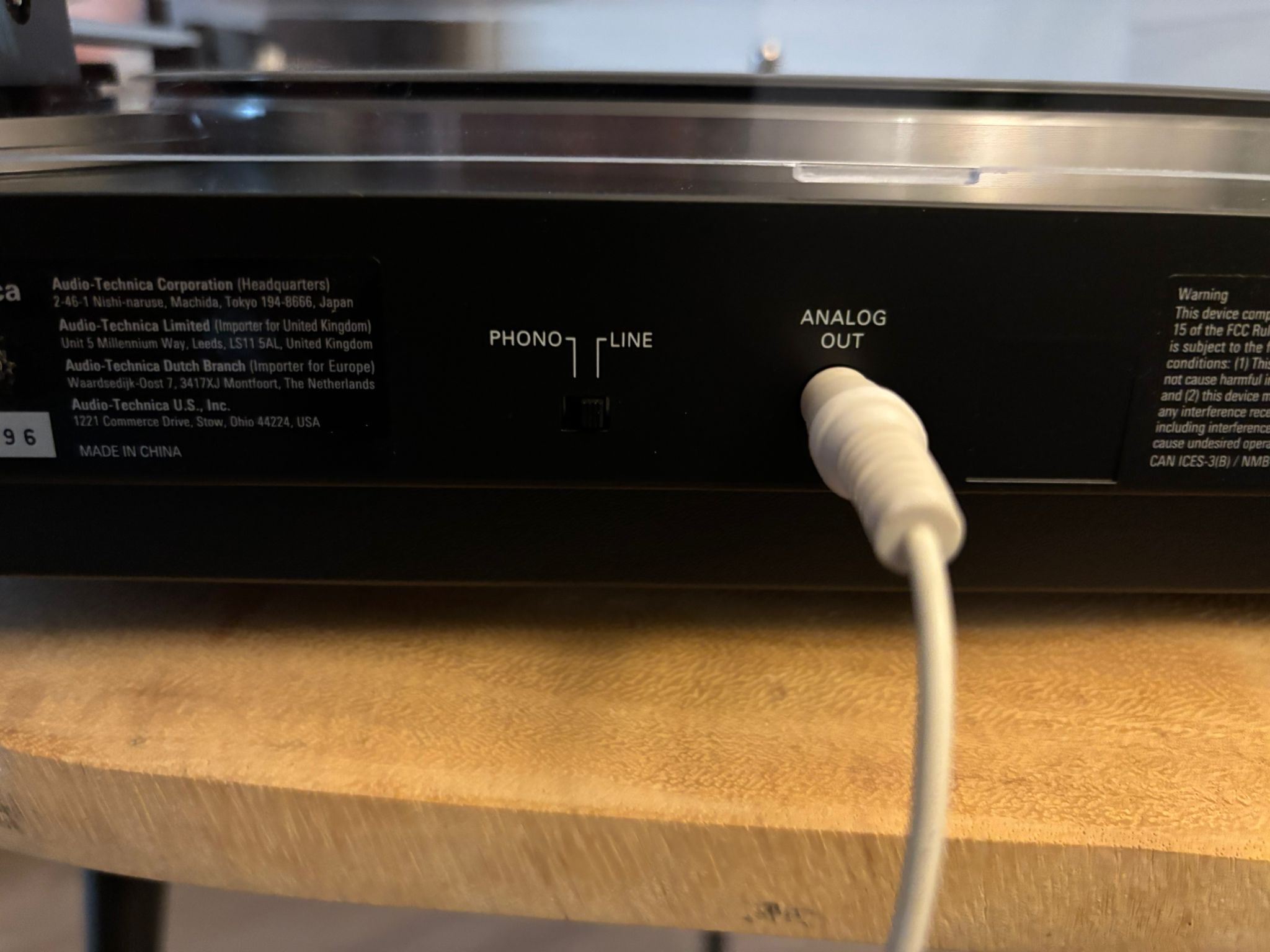Close-up of the Phono/Line switch on the back of a turntable, set to Line, with the Analog Out cable connected